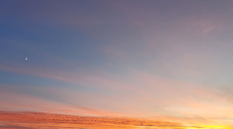 Small moon after a setting sun