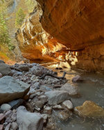 Creek and orange cliffs in Utah.