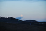 A full moon just moments from setting.